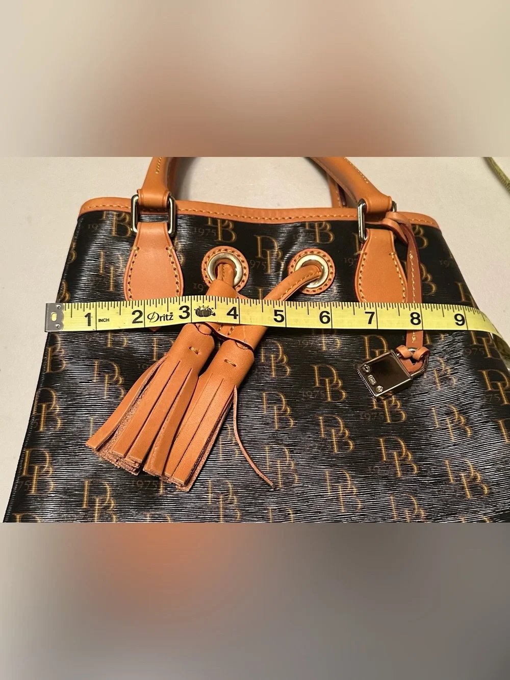 Dooney & Bourke signature brown 1975 DB logo coated canvas bucket bag